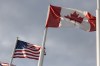 The American and Canadian flags fly at the midway point on the Gordie Howe International Bridge, that connects Windsor, Ontario, and Detroit, Michigan, is shown on Monday, Aug. 24, 2026. THE CANADIAN PRESS/Dax Melmer