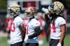 San Francisco 49ers linebackers Jalen Graham, left, Kyahva Tezino, middle, and Fred Warner stand on the field during the NFL team's football training camp in Santa Clara, Calif., Thursday, July 27, 2023. (AP Photo/Jeff Chiu)