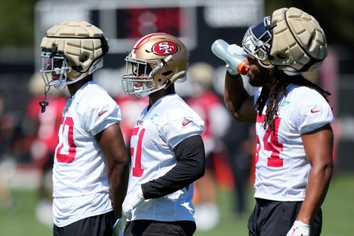 San Francisco 49ers linebackers Jalen Graham, left, Kyahva Tezino, middle, and Fred Warner stand on the field during the NFL team's football training camp in Santa Clara, Calif., Thursday, July 27, 2023. (AP Photo/Jeff Chiu)