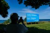 A person takes a picture of the new sign for Lake Ontario at Fifty Point Conservation Area in Grimsby, Ont., on Saturday, Aug. 29, 2026. THE CANADIAN PRESS/Keito Newman