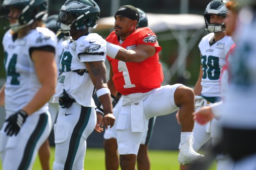 Philadelphia Eagles quarterback Jalen Hurts (1) warms up with teammates during a joint NFL football practice with the New England Patriots, Thursday, Aug. 20, 2026, in Foxborough, Mass. (AP Photo/Steven Senne)