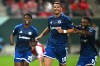 Schalke's Edin Dzeko, center, celebrates scoring during the German soccer cup match between Hallescher FC and FC Schalke 04 in Halle, Germany, Monday Aug. 24, 2026. (Hendrik Schmidt/dpa via AP)