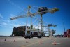 Containers are unloaded from the Manzanillo Bridge container ship at Global Container Terminals' Deltaport facility, at Roberts Bank, in Delta, B.C., on Thursday, July 30, 2026. THE CANADIAN PRESS/Darryl Dyck