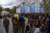 Ukrainian servicemen carry the coffin of fallen soldier Danyil Smyrnov, 21, who was killed on the frontline, during the funeral ceremony in Kyiv, Ukraine, Thursday, Sept. 3, 2026. (AP Photo/Alex Babenko)