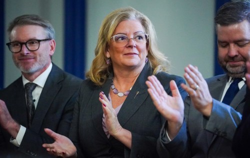 Saskatchewan Minister of Mental Health and Addictions, Seniors and Rural and Remote Health Lori Carr, middle, applauds during a cabinet swearing-in ceremony at Government House in Regina, on Thursday, Dec. 11, 2025. THE CANADIAN PRESS/Heywood Yu