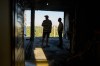 Ivan Datsiv, left, talks to a friend inside his apartment the day after a Russian drone attack struck his building in Kyiv, Wednesday, Sept. 2, 2026. (AP Photo/Francisco Seco)