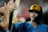 Milwaukee Brewers Cooper Pratt celebrates in the dugout after scoring on a wild pitch by Cincinnati Reds pitcher Sam Moll the fifth inning of a baseball game, Friday, Sept. 4, 2026, in Cincinnati. (AP Photo/Carolyn Kaster)