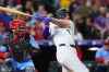 Colorado Rockies' TJ Rumfield, right, watches his RBI double with St. Louis Cardinals catcher Leo Bernal, left, in the fifth inning of a baseball game Saturday, Sept. 5, 2026, in Denver. (AP Photo/David Zalubowski)
