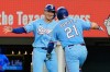 Texas Rangers' Wyatt Langford, left, and Jake Burger (21) celebrate Burger's two-run home run that scored Langford during the fourth inning of a baseball game against the Tampa Bay Rays Sunday, Sept. 6, 2026, in Arlington, Texas. (AP Photo/Tony Gutierrez)