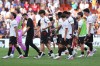 Valencia's head coach Carlos Corberan, third left, and players leave the field after their loss in the Spanish La Liga soccer match against Barcelona in Valencia, Spain, Sunday, Sept. 6, 2026. (AP Photo/Alberto Saiz)