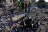 Rescue workers search for victims under the rubble of a building destroyed in an Israeli airstrike in the southern village of Kfar Rumman, Lebanon, Monday, Sept. 7, 2026. (AP Photo/Mohammed Zaatari)