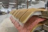 FILE - Wooden hockey sticks are stacked as they move along the assembly line at the Roustan Hockey factory, which is the last major manufacturer of hockey sticks in Canada on Aug. 27, 2025 in Brantford, Ontario. (AP Photo/Kelvin Chan, File)