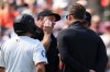 Home plate umpire Chris Guccione, second from left, talks with a trainer and other officials after being hit in the mask by a foul tip during the second inning of a baseball game between the Baltimore Orioles and the Cleveland Guardians, Monday, Sept. 7, 2026, in Baltimore. (AP Photo/Stephanie Scarbrough)