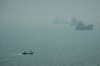 A motorboat travels past commercial vessels anchored amid haze in the Strait of Hormuz off Bandar Abbas, Iran, Monday, Sept. 7, 2026. (AP Photo/Vahid Salemi)