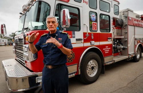 Calgary Fire Chief Steve Dongworth gestures during an interview beside one of the Calgary Fire Department's engines in Calgary, Tuesday, Aug. 11, 2026.THE CANADIAN PRESS/Jeff McIntosh