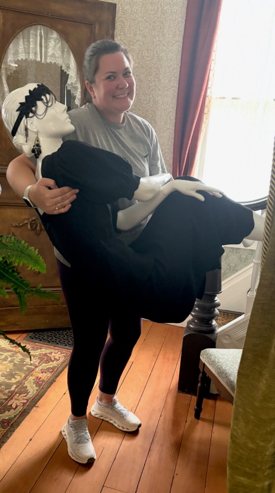 Gillian Potvin, 39, holds a mannequin while setting up for a Hidden Attic exhibition which was held in June. Potvin has been volunteering doing marketing and events planning for the Nellie McClung Museum of Canada since it opened in 2017. (Nellie McClung Museum / Supplied)