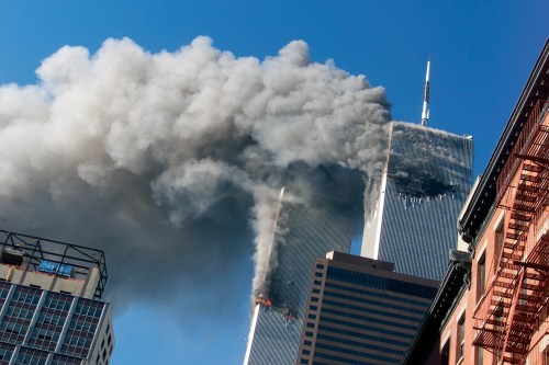 Smoke rises from the burning twin towers of the World Trade Center after hijacked planes crashed into the towers, Sept. 11, 2001, in New York.  THE CANADIAN PRESS/AP-Richard Drew