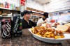 Smoked meat sandwiches and poutine wait to be served next to a can of Canadian made Fleischer's black cherry soda, which replaced the long used Cott's black cherry soda at Schwartz's deli, in Montreal on Tuesday, Aug. 25, 2026. THE CANADIAN PRESS/Christopher Katsarov