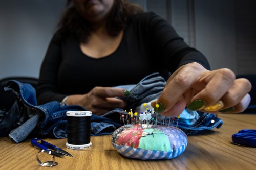 Bella, an attendee of the Clothing Repair Cafe, sticks a pin into a homemade pincushion at the University of Alberta in Edmonton on Sept. 19, 2026. THE CANADIAN PRESS/Amanda May Erickson