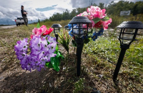 JOHN WOODS / FREE PRESS A friend of four teens, killed in a crash Sunday night, visits a memorial placed at the intersection of Highway 8 and Provincial Road 229 Tuesday,