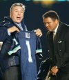 Former Canadian boxing champ George Chuvalo presents Muhammad Ali a Toronto Argonauts jersey at a Parkinson's Disease fundraiser during half time of the Toronto Argonauts vs Ottawa Renegades CFL matchup in Toronto on Sunday Oct. 20, 2002. THE CANADIAN PRESS/Frank Gunn