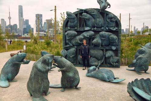 Kent Monkman stands next to his new permanent sculpture, dubbed “The Colony,” as shown in this handout photo. THE CANADIAN PRESS/Handout-Michael Seleski (Mandatory Credit)
