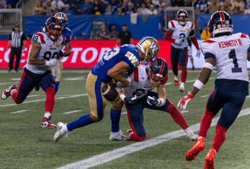 ROBERT LEE / FREE PRESS
                                Montreal Alouettes defensive back Nate Beauchemin hits Winnipeg Blue Bombers wide receiver Tommy Nield at the goal line to force a fumble on Friday.