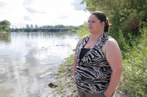 Jayclyn Morrissette on the banks of the Red River where she rescued a two-year-old girl and her dad from drowning last week. (Ruth Bonneville / Free Press)