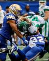John Woods / THE CANADIAN PRESS FILES
                                Winnipeg Blue Bombers linebackers Kyrie Wilson (left) and Michael Griffin stop Saskatchewan Roughriders running back A.J. Ouellette (45) during last season&rsquo;s Banjo Bowl.