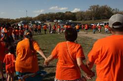 Participants take part in a round dance following an Orange Shirt Day Walk last September in Brandon. (Tim Smith / The Brandon Sun files)