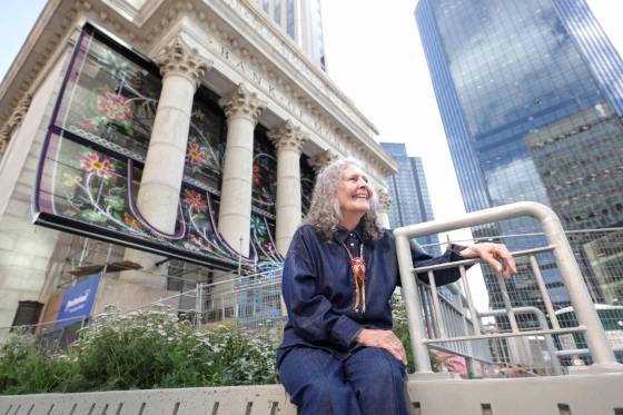 Métis beadwork artist Jennine Karachi with her large-scale, chain-link Métis public artwork that now graces the outside of MMF’s Bank of Montreal building at Portage and Main. (Ruth Bonneville / Free Press)
