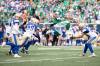Saskatchewan Roughriders running back Quali Conley (24) leaps in the air as the Winnipeg Blue Bombers defence closes in during the first half. (Kayle Neis / The Canadian Press)