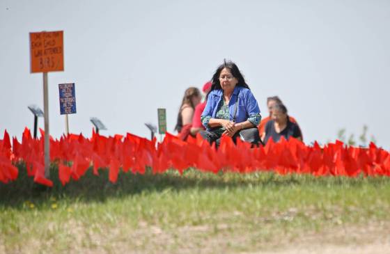 In this May 2026 photo, Brandon Residential School survivor Marge Prince looks for her own name among the orange flags that hold the names of 3,000 of known children who attended the school over the years. (Matt Goerzen / The Brandon Sun files)
