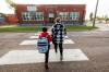 Ethan Minski, 7, walks to school for his first day of Grade 2 with his mom Christy Smolik at Prince Edward School on Wednesday morning. (Mike Deal / Free Press)