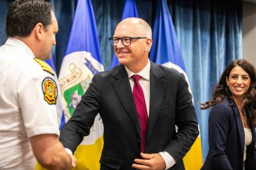 MIKAELA MACKENZIE / FREE PRESS FILES
                                Mayor Scott Gillingham (right) shakes hands with Winnipeg Fire Paramedic Service chief Ryan Sneath during a July 28 news conference on the new crisis-response model. A proposal on the new system is set to be presented to the city&rsquo;s executive policy committee.
