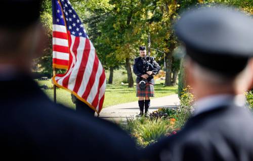JOHN WOODS / THE CANADIAN PRESS
                                A piper plays Amazing Grace as people participate in the 25th Annual 9/11 Memorial Service at the International Peace Garden in Boissevain Friday.