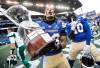 JOHN WOODS / THE CANADIAN PRESS 

Winnipeg Blue Bombers’ Trey Vaval (23) and Nuer Gatkuoth (40) celebrate a win over the Saskatchewan Roughriders with the Banjo Bowl trophy following CFL action in Winnipeg on Saturday.
