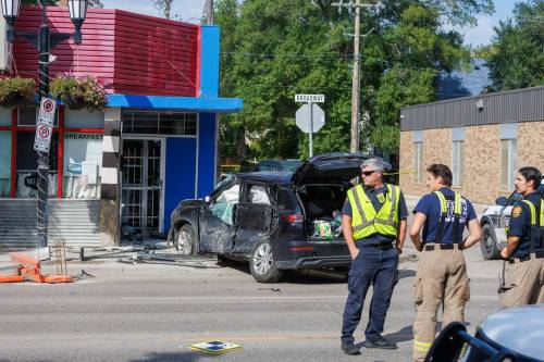Winnipeg police at the scene following a police pursuit near Broadway and Langside Street Friday afternoon. (Mike Deal / Free Press)