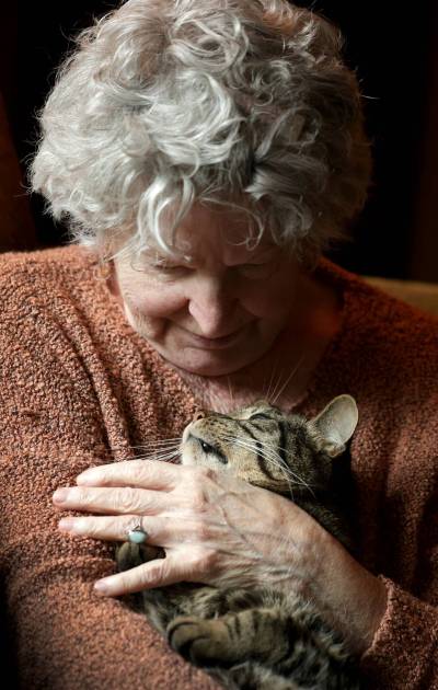 Ruth Bonneville / Free Press
                                Shannon McGunigal cuddles Rhythm, one of her four cats.
