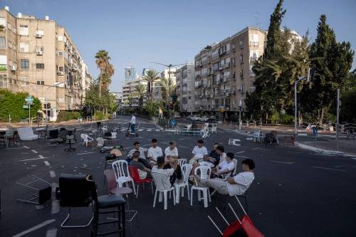 Oded Balilty / The Associated Press files
                                Israeli youths sit at a junction on a car-free road in 2023 during the Jewish holiday of Yom Kippur in Ramat Gan, Israel. Israel comes to an almost complete standstill on Yom Kippur.