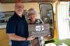 BROOK JONES / FREE PRESS
                                David Balzer, 60, has converted his Triple E Surfside camper trailer called Chatterbox into a mobile recording studio in which he records people&rsquo;s stories of gratitude and belonging. The associate professor of communications and media at Canadian Mennonite University was at the Elim Mennonite Church in Grunthal, Man., to record stories from varous church members on Sunday, Sept. 13, 2026. Pictured: Chatterbox producer David Balzer wife, Kathryn Balzer standing outside their Triple E Surfside camper trailer called Chatterbox.