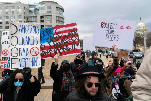 Jose Luis Magana / Associated Press files
                                In this 2025 photo, people rally against Elon Musk and the Department of Government Efficiency (DOGE) outside the U.S. Department of Labor in Washington.
