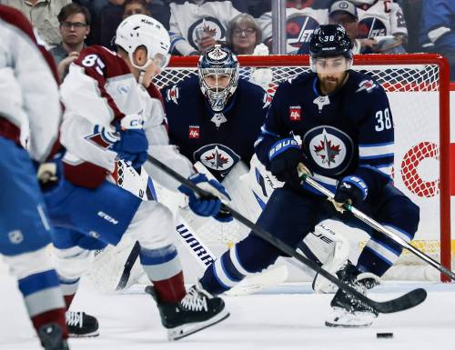 JOHN WOODS / FREE PRESS
                                Winnipeg Jets&rsquo; goaltender Stuart Skinner keeps his eyes on the puck as teammate Mario Ferraro defends against Colorado Avalanche&rsquo;s Nikita Prishchepov during the second period of the Jets pre-season game against the Avs, Monday in Winnipeg.