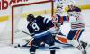 JOHN WOODS / FREE PRESS
                                Winnipeg Jets forward Alex Iafallo scores on Edmonton Oilers goaltender Devon Levi as Shakir Mukhamadullin defends during first period NHL action in Winnipeg on Monday.
