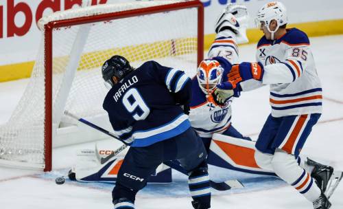 JOHN WOODS / FREE PRESS
                                Winnipeg Jets forward Alex Iafallo scores on Edmonton Oilers goaltender Devon Levi as Shakir Mukhamadullin defends during first period NHL action in Winnipeg on Monday.