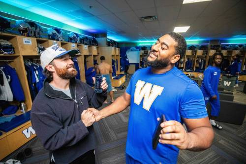MIKAELA MACKENZIE / FREE PRESS
                                Winnipeg Blue Bombers punter &mdash; and commissioner of the team&rsquo;s NFL fantasy football league &mdash; Jamieson Sheahan (left) shakes hands with teammate Micah Vanterpool after practice Wednesday. Vanterpool said the league is great for building club-wide camaraderie.
