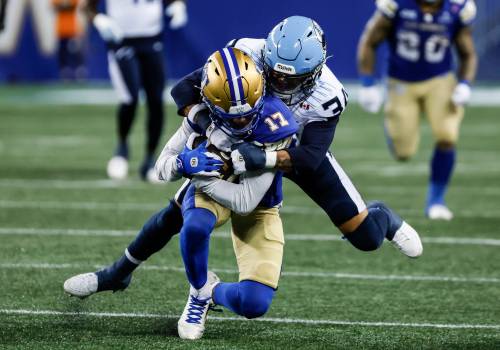 John Woods / THE CANADIAN PRESS
                                Winnipeg Blue Bombers&rsquo; Dorian Singer gets tackled by Toronto Argonauts&rsquo; Bubba Bolden in the first half in Winnipeg on Friday.