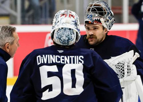 JOHN WOODS / FREE PRESS
                                Winnipeg Jets goaltenders Domenic DiVincentiis (50) and Stuart Skinner (74) talk to a coach during training camp on Sept. 20.