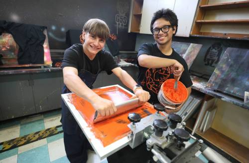 RUTH BONNEVILE / FREE PRESS
                                LOCAL - TRC shirts Elmwood High School students Daniel Concepcion in Grade 12 (glasses) and Lexington Zastre in grade 10 of the shops program, work together screen printing TRC shirts during their class at Elmwood High School (headquarters/shops for Elmwood Supply Co.) on Monday. Story: TRC SCHOOLS: A high school student-run biz, Elmwood Supply Co is printing 800+ TRC designs on black t-shirts with logos of an Elmwood High alum&rsquo;s design for Orange Shirt Day. The group secured a grant from WSD to distribute shirts to every single student. See story by Maggie Sept 28th, 2026