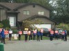 A group of protesters hold up signs outside Gao Bing Chen's home in Surrey, B.C., in a 2020 handout photo. Gao has been awarded $275,000 in defamation damages from a man who livestreamed the protests, which a judge says made baseless claims about Gao. THE CANADIAN PRESS/Handout - Gao Bing Chen (Mandatory Credit)
